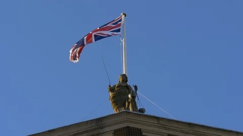 Slow motion - British flag flying above a building in England, floating in wind  Stock Footage 85674398