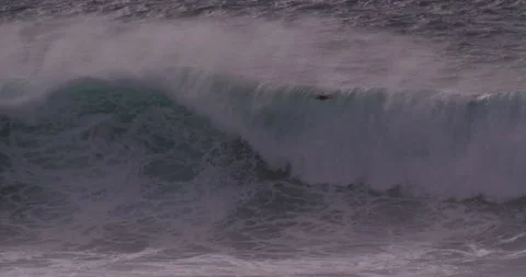 Slow motion of broad ocean waves swimming towards seashore on cloudy evening Stock Footage 156143235