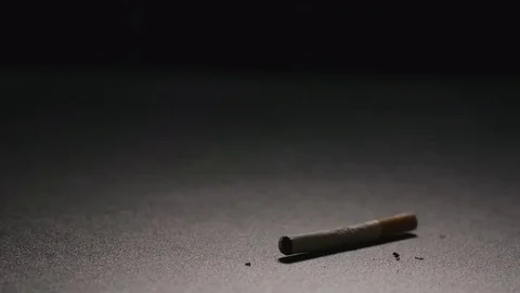 SLOW MOTION: Broken cigarette falls on a floor Stock Footage 72273503