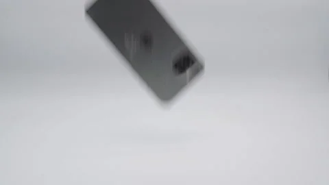 Slow motion of broken smartphone falling. Isolated on white background Stock Footage 199000074