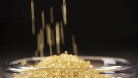 Slow motion brown sugar pour in a bowl close up Stock Footage 95784149