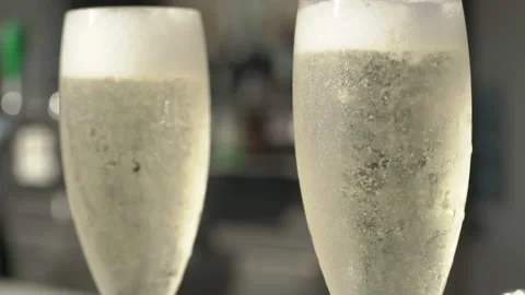 Slow Motion of bubbles in champaign glass at high end restaurent with foa Stock Footage 130904904