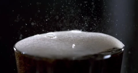 Slow motion of bubbles forming and popping in a glass of soda Stock Footage 337228966