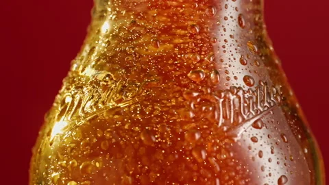 Slow motion bubbles rise up in a beer bottle Stock Footage 148160922