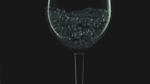Slow Motion Bubbles Rising in Clear Liquid Inside Elegant Wine Glass 库存影片 334642305