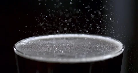 Slow motion bubbles rising in a glass of drink with water droplets Stock Footage 337228965