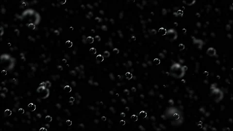 Slow motion bubbles rising in soda / carbonated drink on black background - Stock Footage 110699602