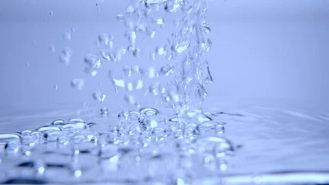 Slow motion bubbles in water, close up with light shining on droplets. Stock Footage 116448771