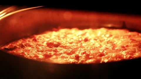 Slow Motion Bubbling Melted Cheese Baking in Oven Close Up Stockbeeldmateriaal 330943519