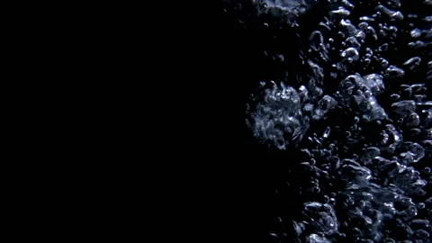 Slow motion bubbling in water on black with space Stock Footage 102932368