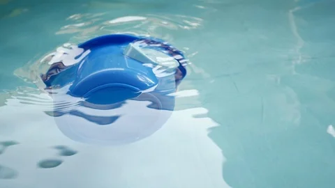 Slow motion bucket floating on clean water of blue swimming pool Stock Footage 89211438