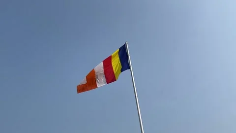 Slow motion Buddhist flag in the wind blue sky negative copy space background Stock Footage 222946158