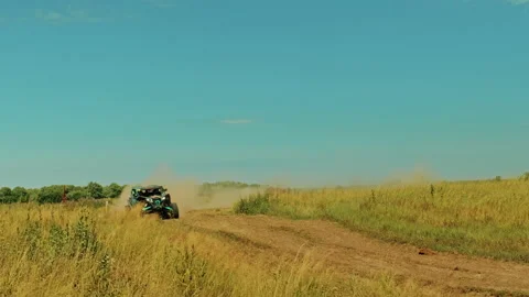 SLOW MOTION: Buggy car is driving fast in a cross country road. Fast rally au Stock Footage 219933856
