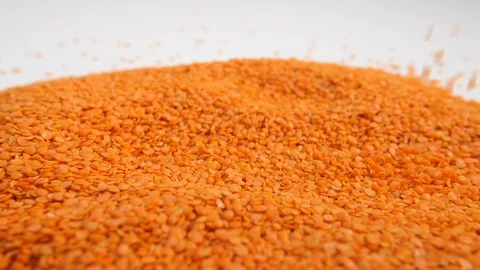 Slow motion bulk dry red lentils with a white trail a portion legumes Stock Footage 88338376