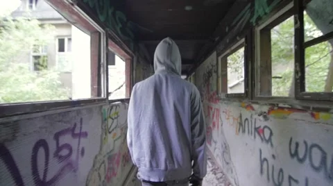 Slow motion of a bum drinking in an abandoned house Stock Footage 58612353