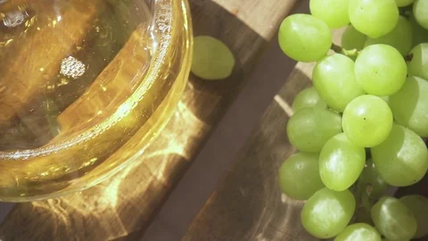 Slow motion a bunch of grapes on the table and a carafe of drink Stock Footage 89030722