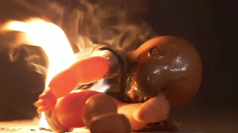 Slow motion burning doll from house fire 4K Stockbeeldmateriaal 159782549