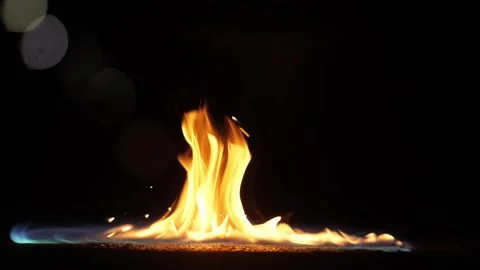 Slow motion of a burning match fall in a gasoline puddle. Beauty flame in dark Stock Footage