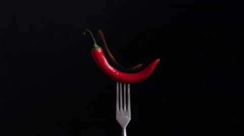 Slow motion of burning red chilli pepper on a fork Stock Footage 60711199