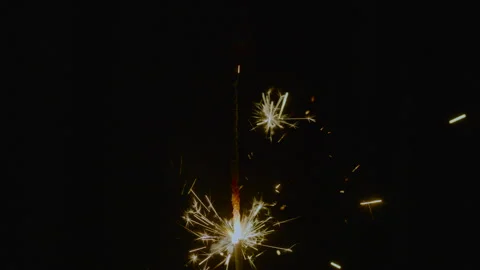 Slow Motion. Burning sparkler with bright golden sparks Stock Footage 323708748