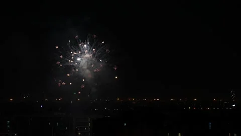 Slow Motion of Burst Spreading Fireworks Being Set Off Between Building At Stock Footage 229074431