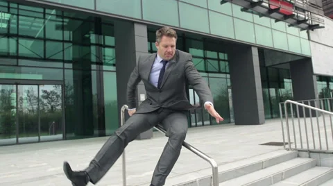 Slow Motion: Businessman Slides Down The Rail And Falls. Stock Footage 35252592