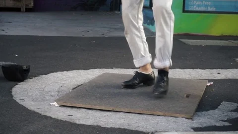 Slow motion of a Busker artist dancing tip tap on the street Stock Footage 73232809