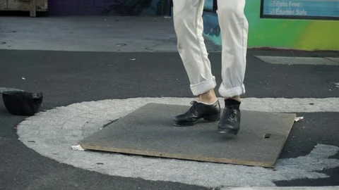 Slow motion of a Busker artist dancing tip tap on the street Stock-Footage 73235294