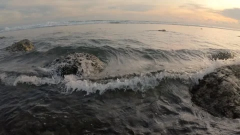 Slow motion of calm waves on the beach at sunset Stock Footage 319906367