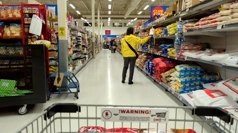 Slow motion of the camera chasing a woman buying food Stock Footage 236832315