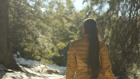 Slow motion camera follows active young brunette woman hiker in yellow jacket Stock-Footage 292539333