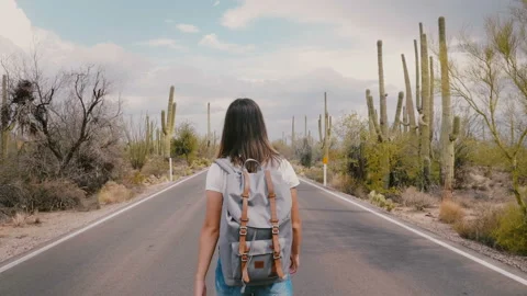 Slow motion camera follows young happy tourist woman with backpack walking on Video stock 102533629