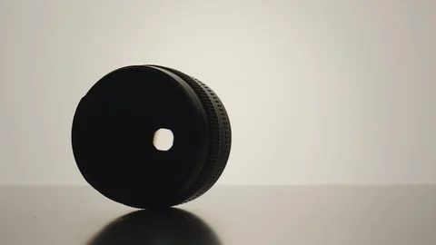 SLOW MOTION: Camera lens spinning on the white surface Vídeos de archivo 101622034