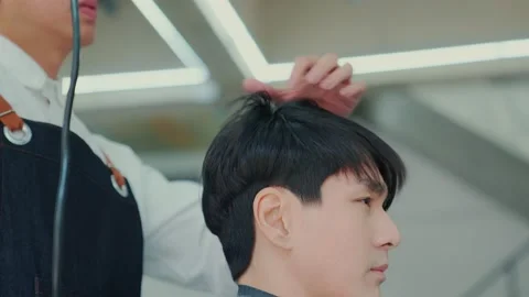 Slow motion camera movement. After the professional barber cut the hair, use  Stock Footage 153965505
