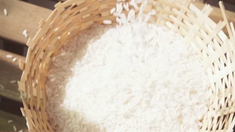 Slow motion camera movement over falling rice Stock Footage 88947977