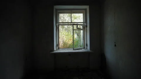 Slow motion camera movement to window of room in abandoned apartment building Video stock 165869974