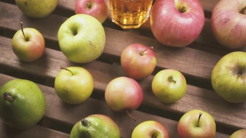 Slow motion the camera moves from the apples on the table to a glass of juice Stock Footage 88097668