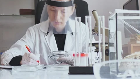Slow motion. The camera moves from bottom to top. Adult young woman researcher Stock-Footage 241666046