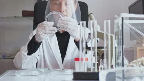 Slow motion. The camera moves from bottom to top. Adult young female researcher Stock Footage 241666551