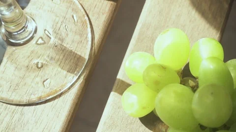 Slow motion the camera moves from a cluster of grapes to a drink in a glass Stock Footage 89030483