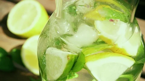 Slow motion the camera moves from the decanter with citrus drink to the decanter Stock Footage 92208867