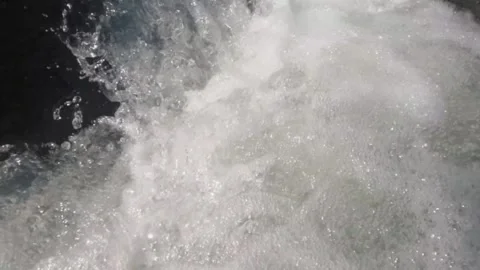 Slow-motion camera moves over the splashes of a clear mountain river Stock Footage 323150658