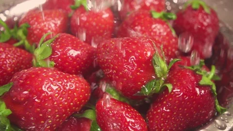 Slow motion the camera moves to the strawberry under the water Stock Footage 90258359