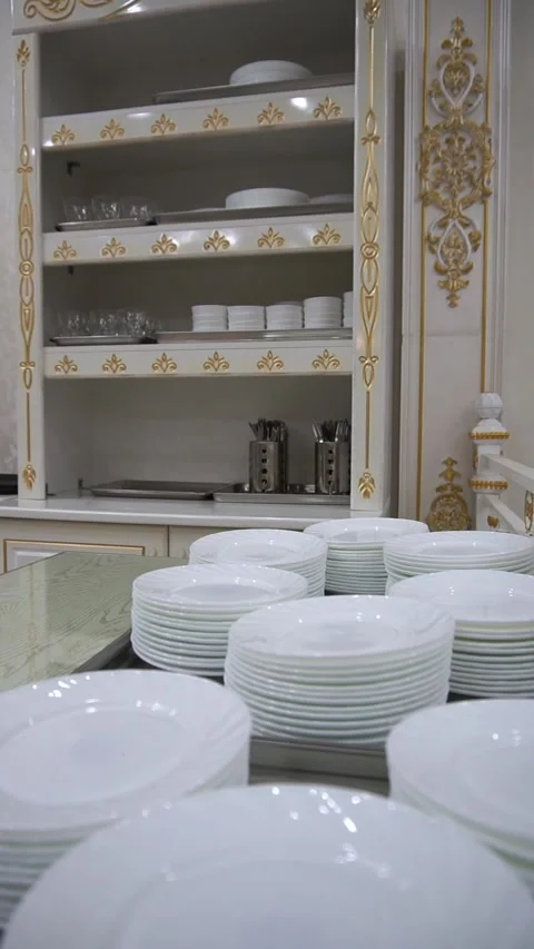 Slow motion camera panning of stacks of clean white ceramic plates on a table wi Stock Footage 341513999