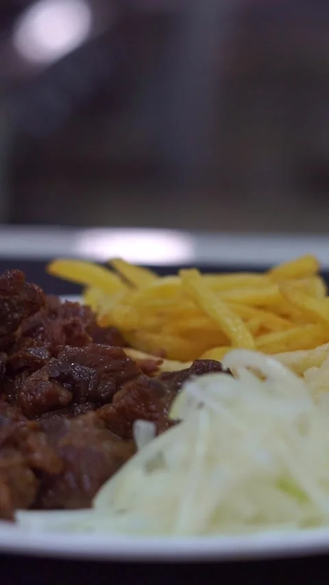 Slow motion camera panning of traditional roasted beef meat served with crispy f Stock Footage 341464853