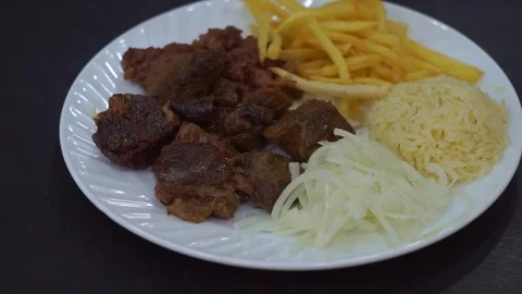 Slow motion camera panning of traditional kazan kebab with roasted meat, crispy  Stock Footage 341464916