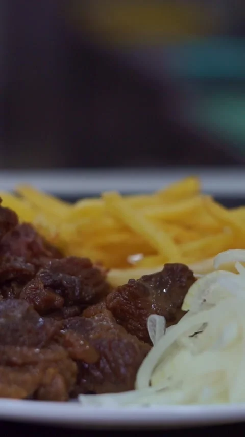 Slow motion camera panning of traditional roasted beef meat served with crispy f Stock Footage 341464917
