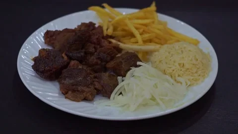 Slow motion camera panning of traditional kazan kebab with roasted meat, crispy  Stock Footage 341464919