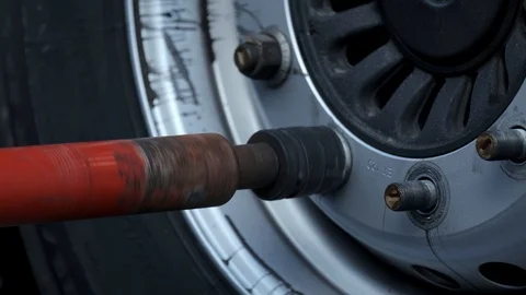 Slow motion, camera removes process of replacing wheel on truck in car workshop Stock Footage 119053554
