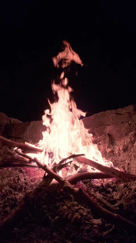 Slow Motion Campfire Burning Brightly in Stone Fire Pit at Night Stock Footage 342113385